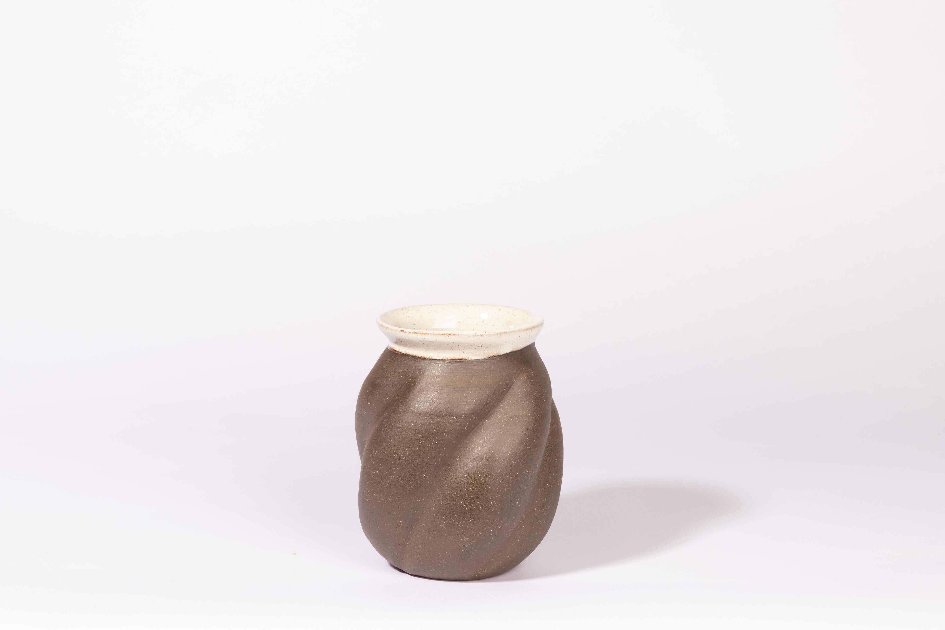 Altered dark clay vase