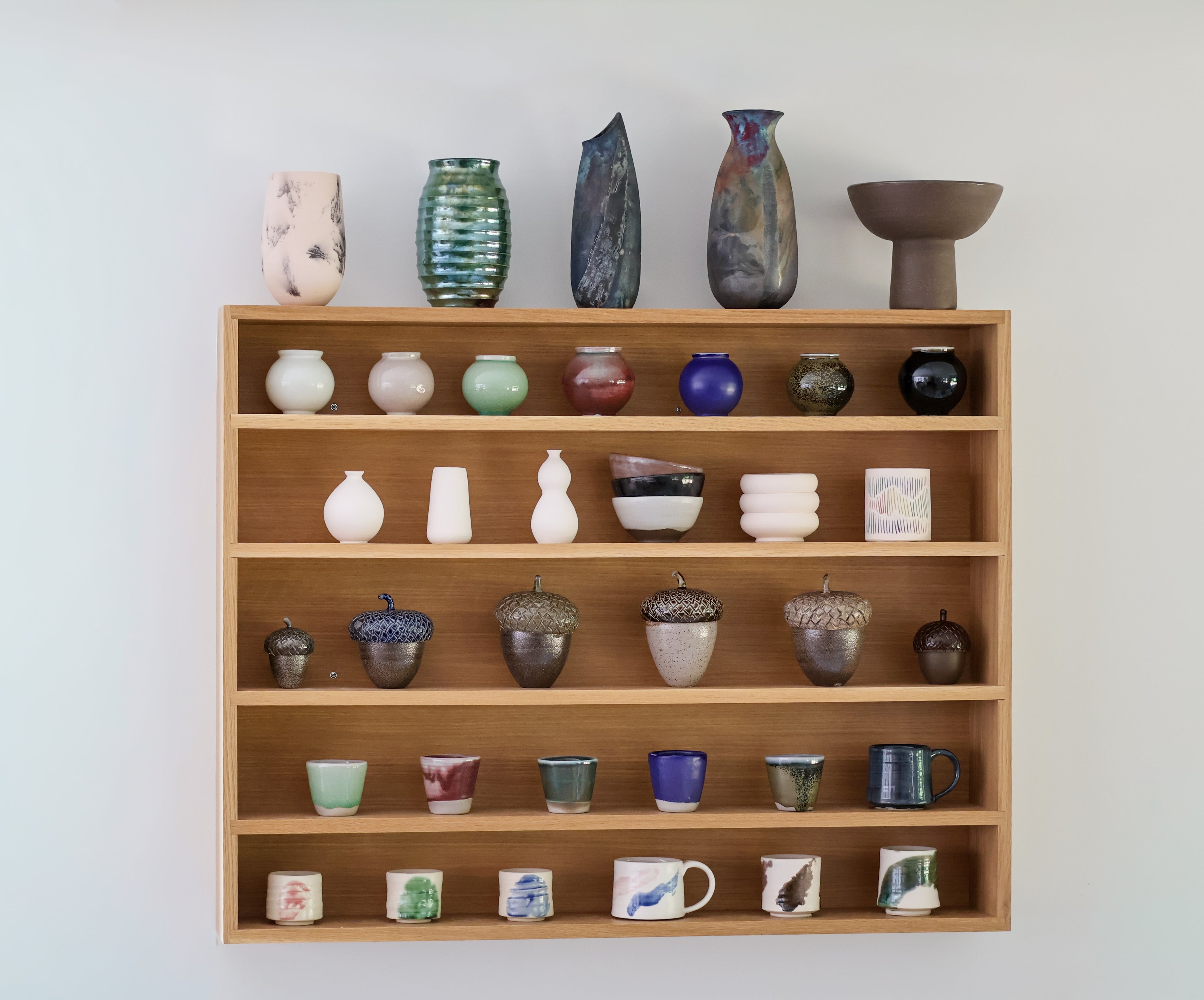 Wood shelf with various ceramic pieces made by Christine